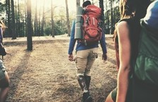 backpackers walking in forest
