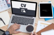recruiter screening résumé on laptop