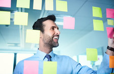 Businessman reading project post-it notes